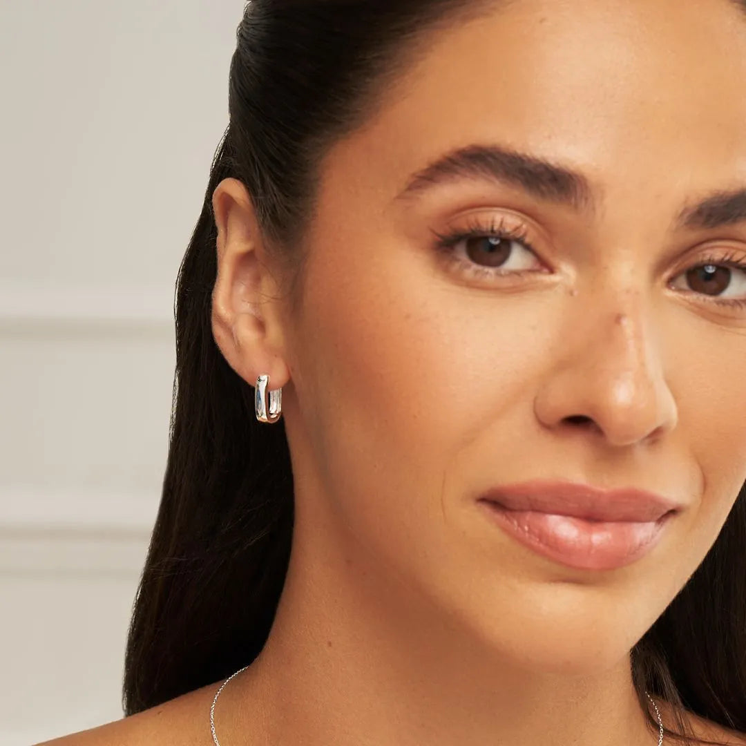 Silver hoop earrings on model close up