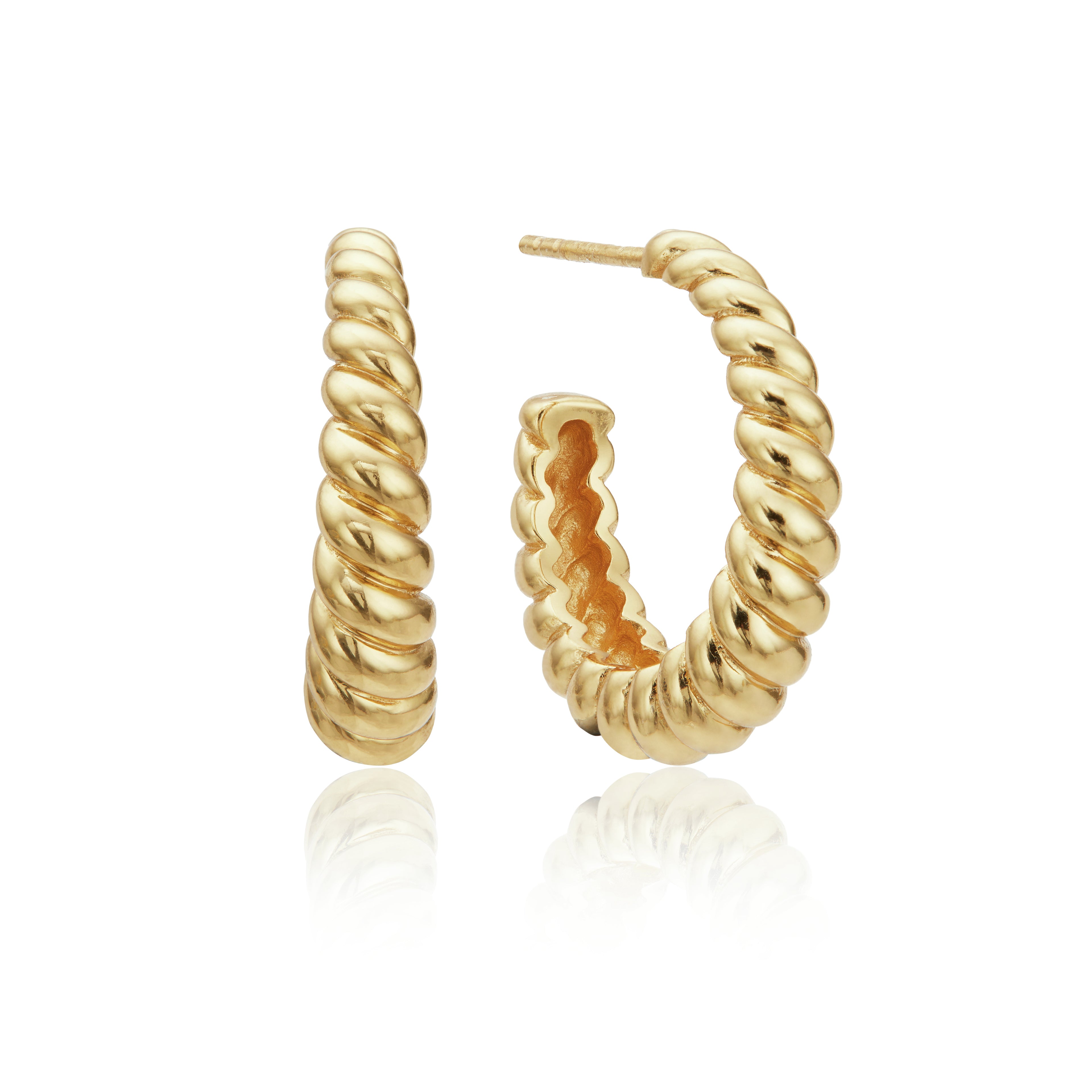 Gold large twisted rope hoop earrings on a white background
