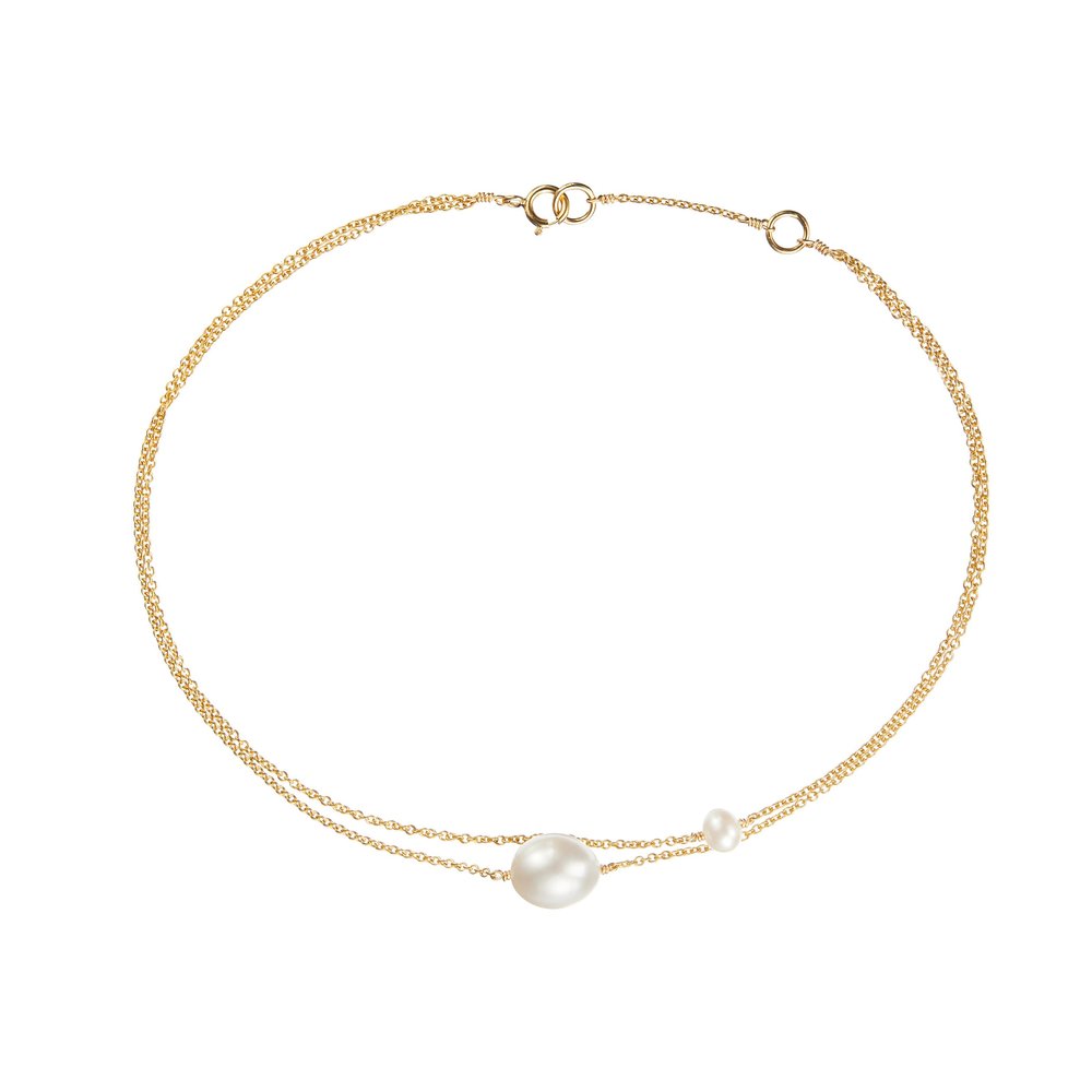 Gold layered large and small pearl anklet on a white background