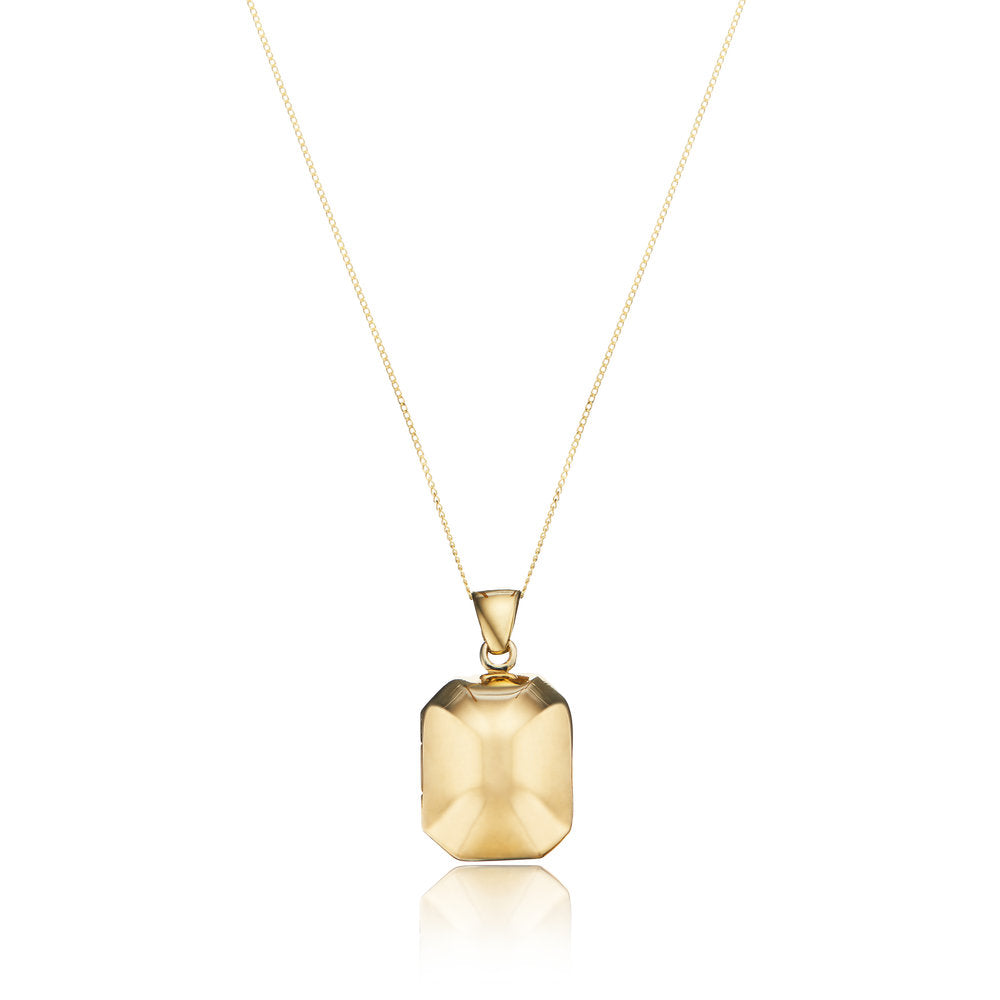 Solid gold ball locket on a white background