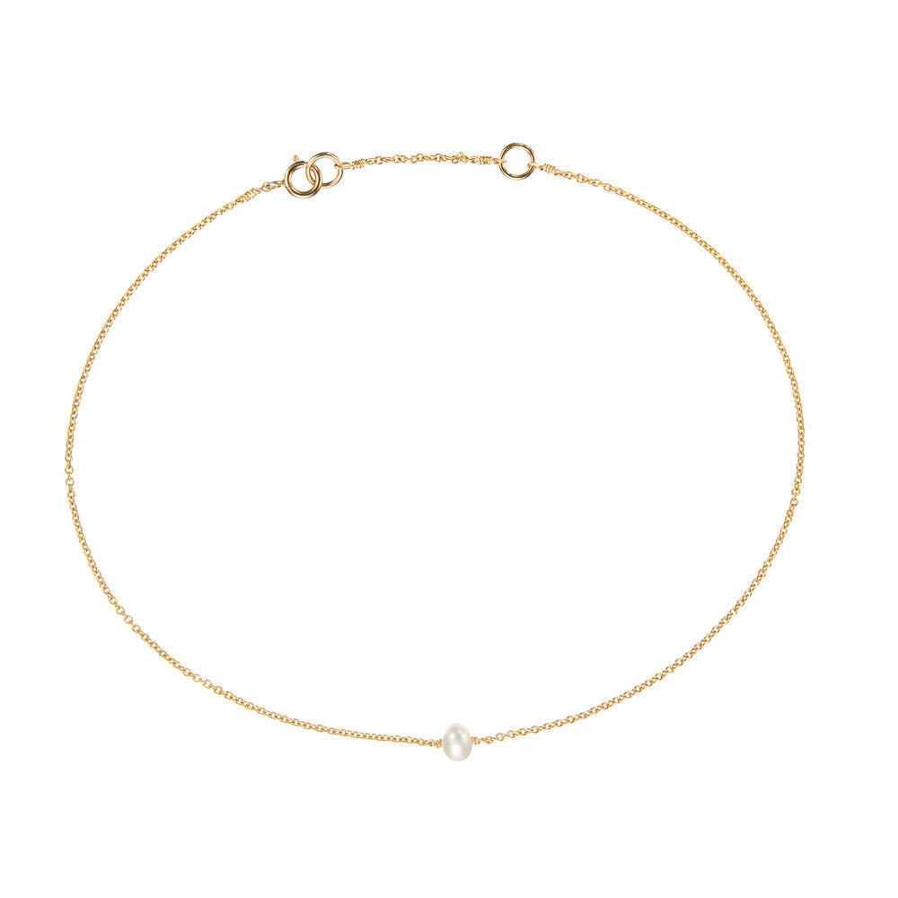 Gold small pearl anklet on a white background