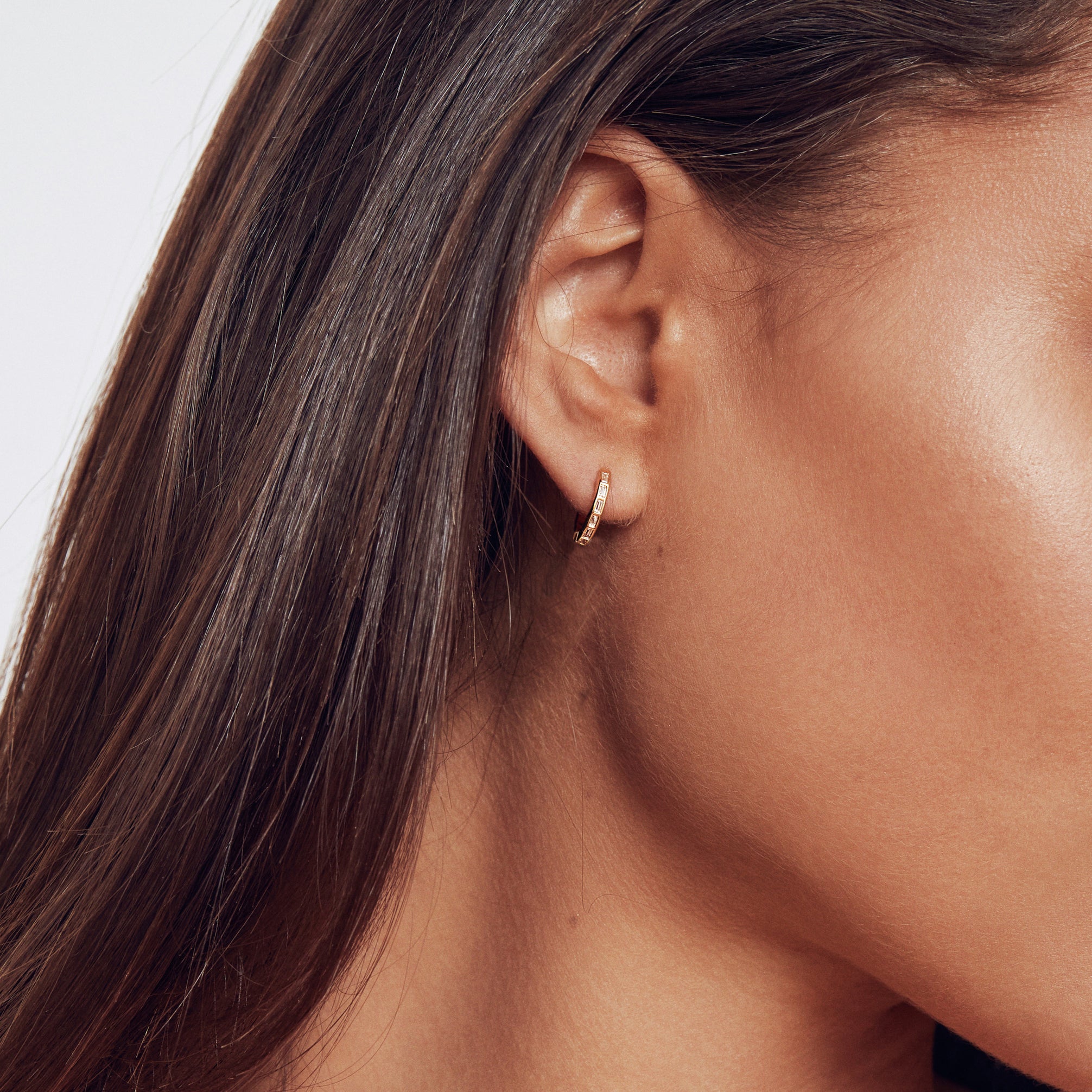 Gold diamond style baguette medium hoop earring in one ear