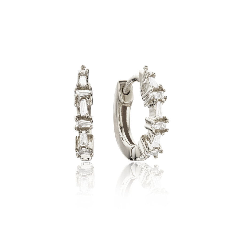 Silver diamond style baguette huggie hoop earrings on a white background