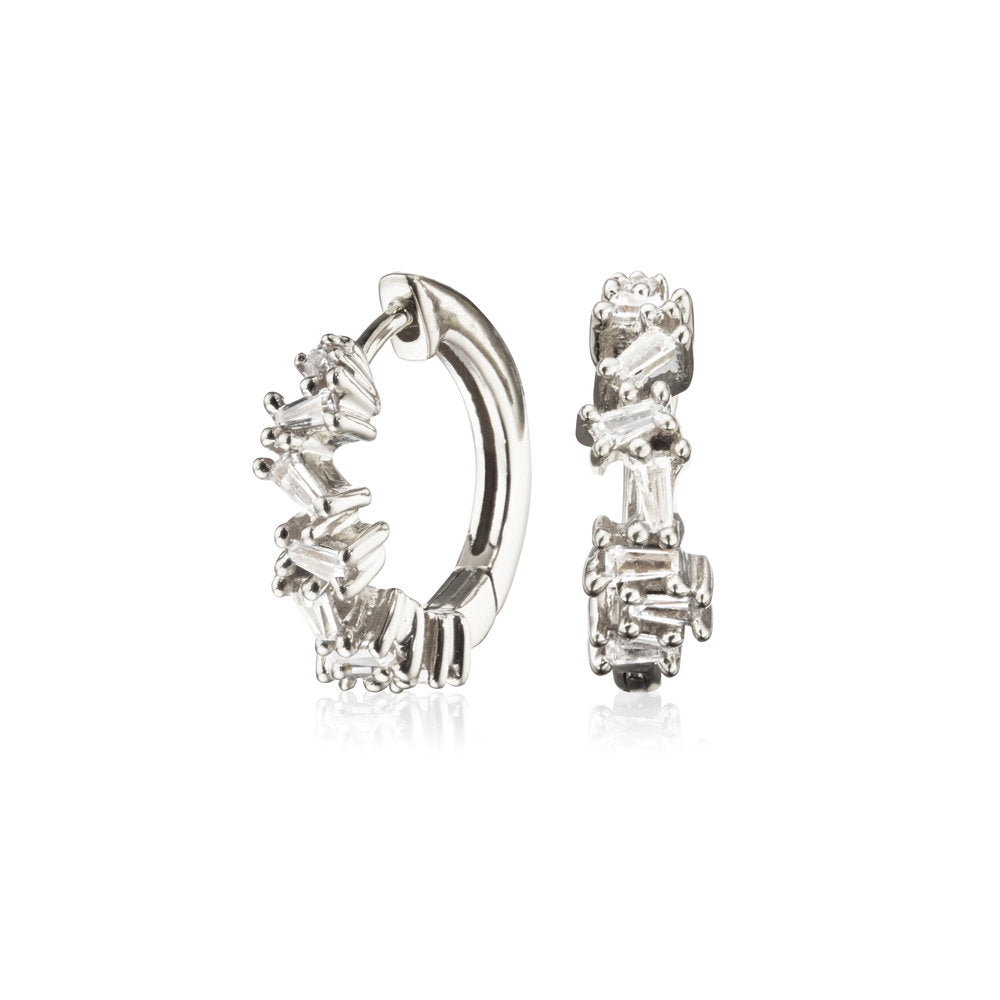 Silver diamond style jagged huggie hoop earrings on a white background