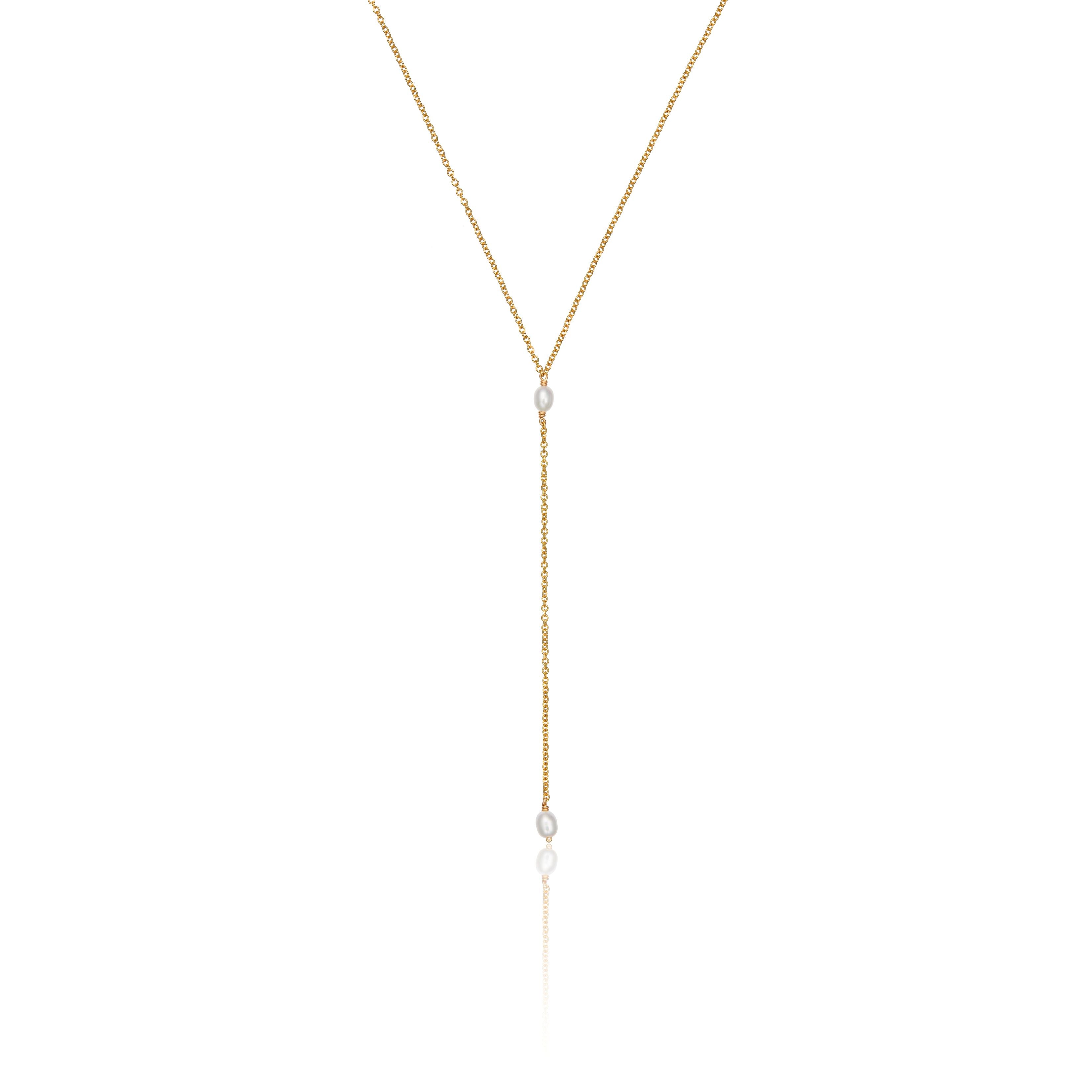 Gold double seed pearl lariat necklace on a white background