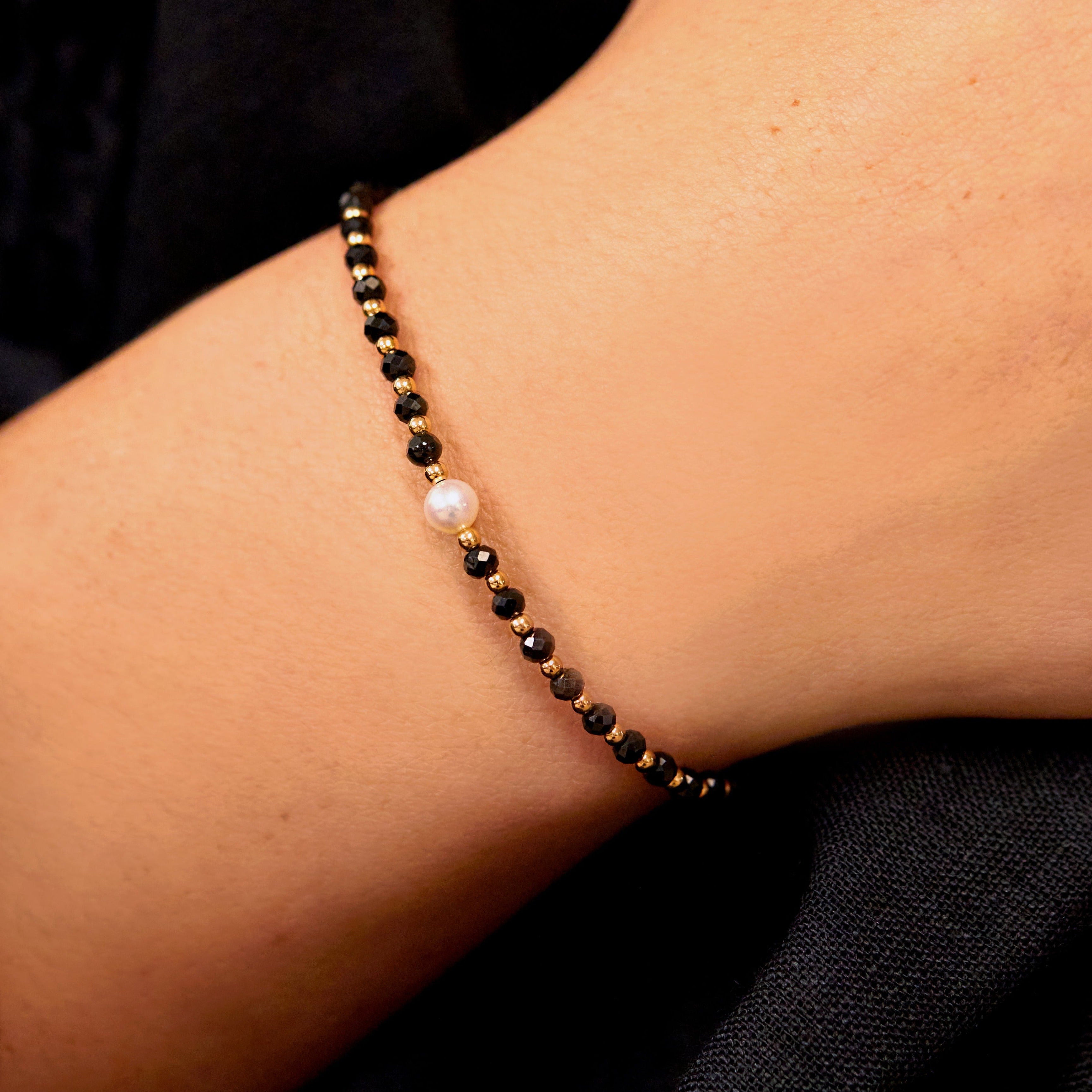 Gold spinel gemstone bracelet on a wrist