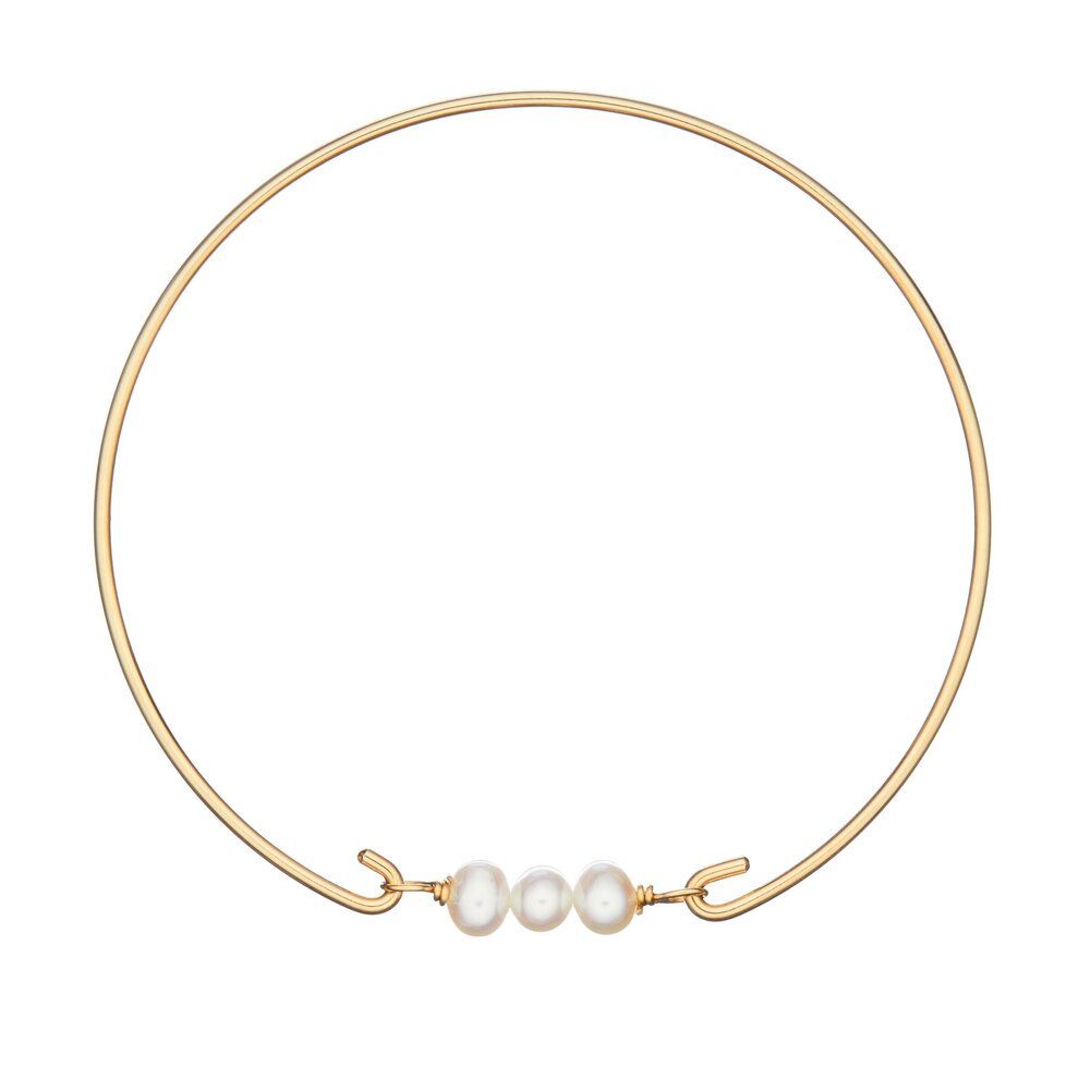Gold cluster pearl bangle on a white background