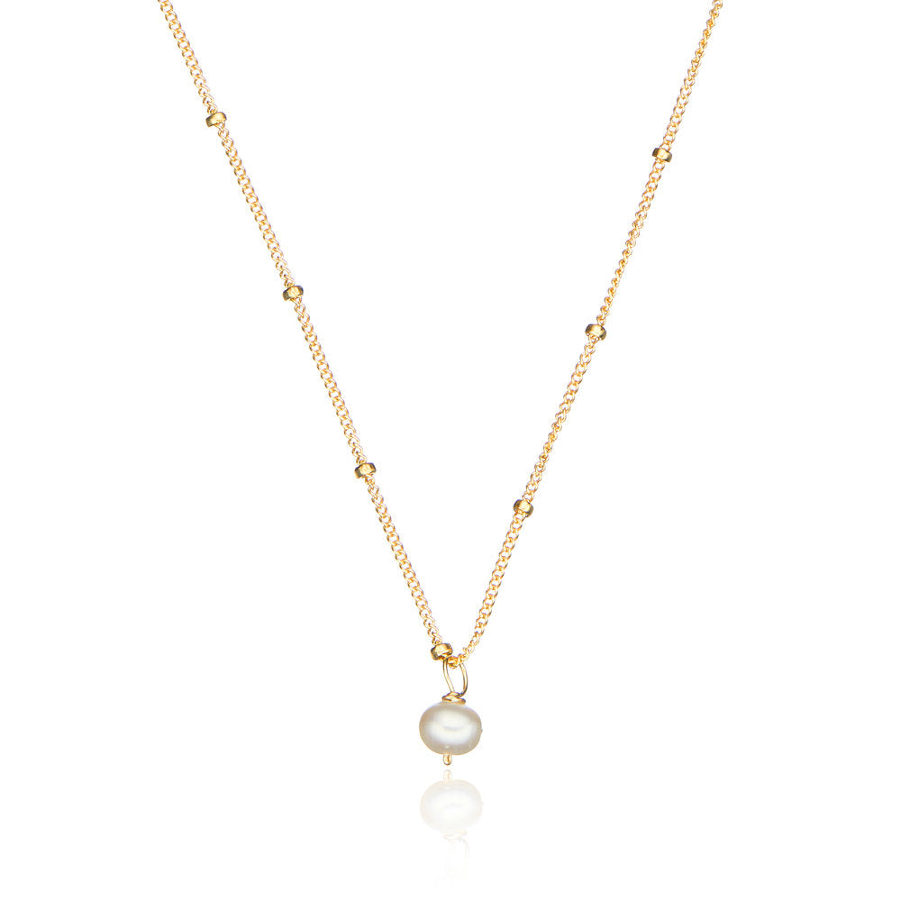 Gold single pearl satellite necklace on a white background
