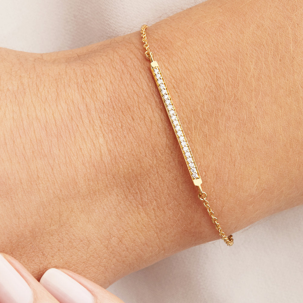 Gold diamond style bar bracelet on a wrist