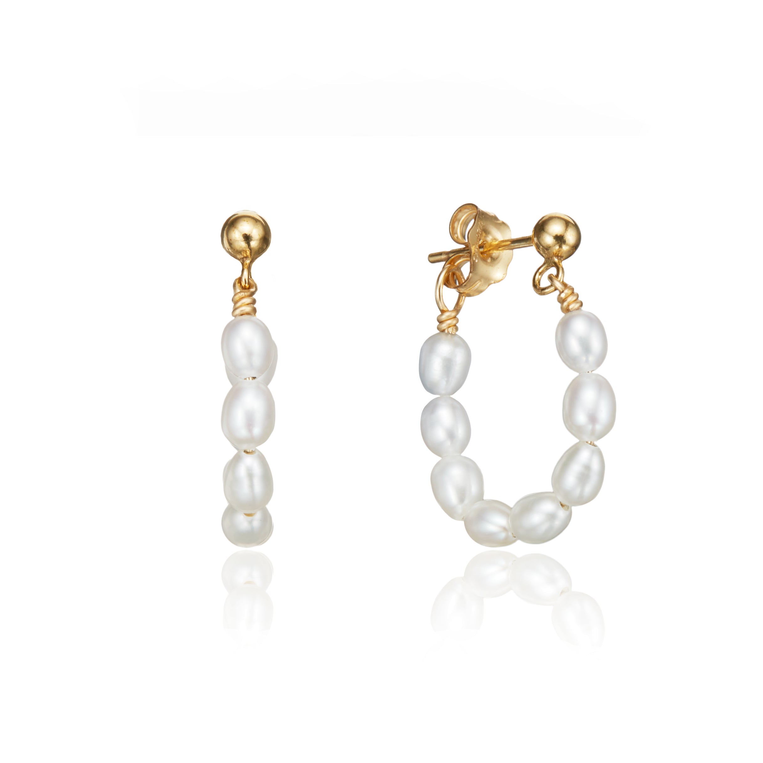 Gold seed pearl hoop earrings on a white background