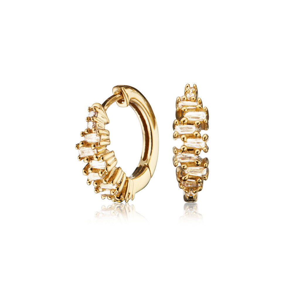 Gold diamond style stacked baguette huggie hoop earrings on a white background