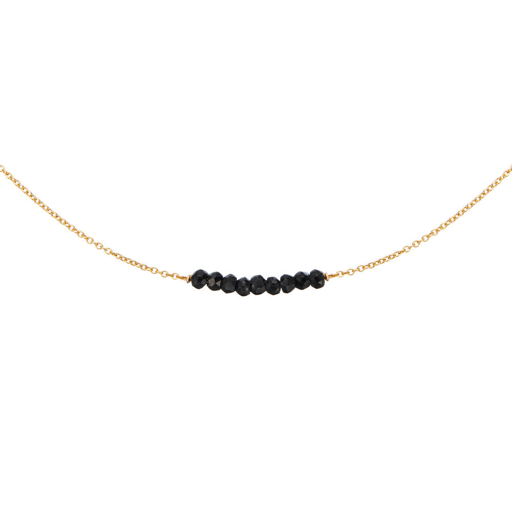 Gold spinel gemstone cluster choker on a white background