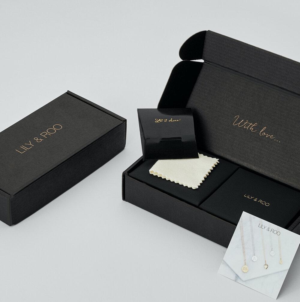 Black gift wrapping jewellery boxes on a white background