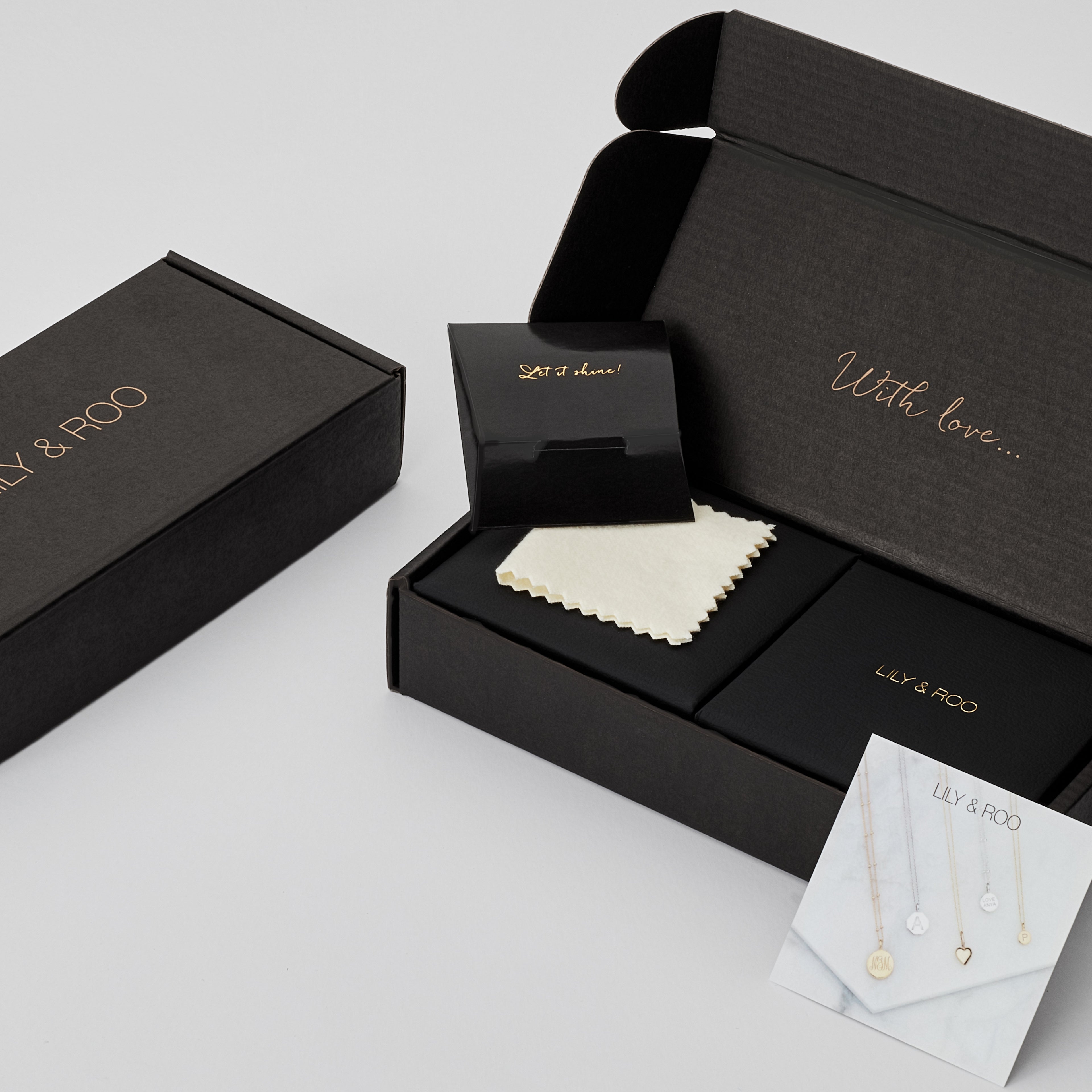 Black gift wrapping boxes open and closed in the colour black