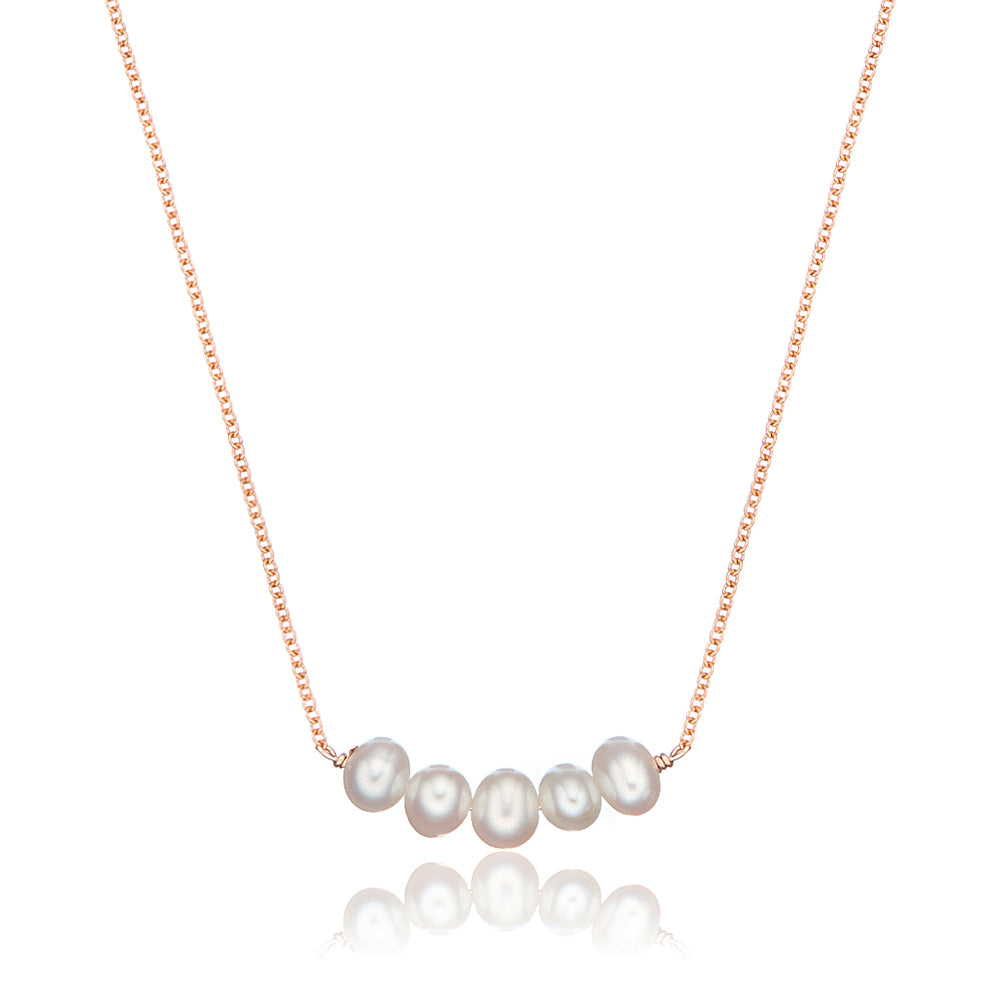 Rose gold pearl cluster necklace on a white background
