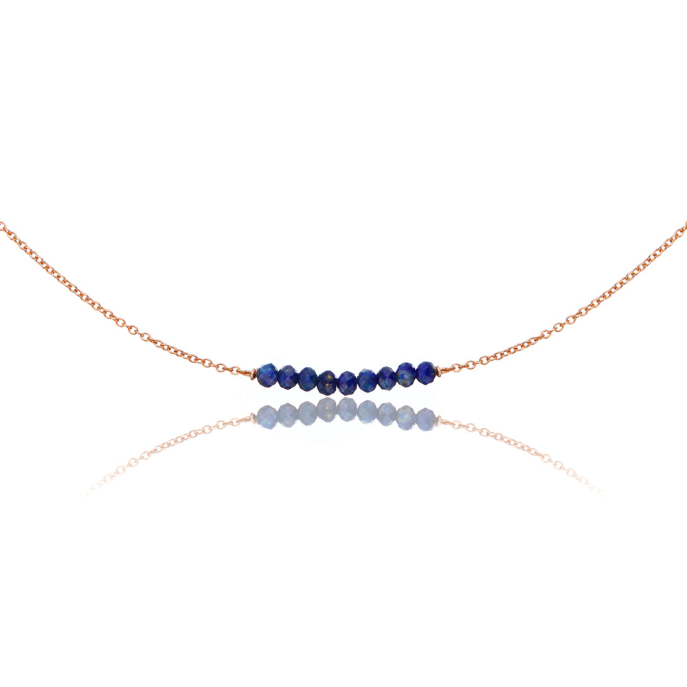 Rose gold lapis gemstone cluster choker on a white background