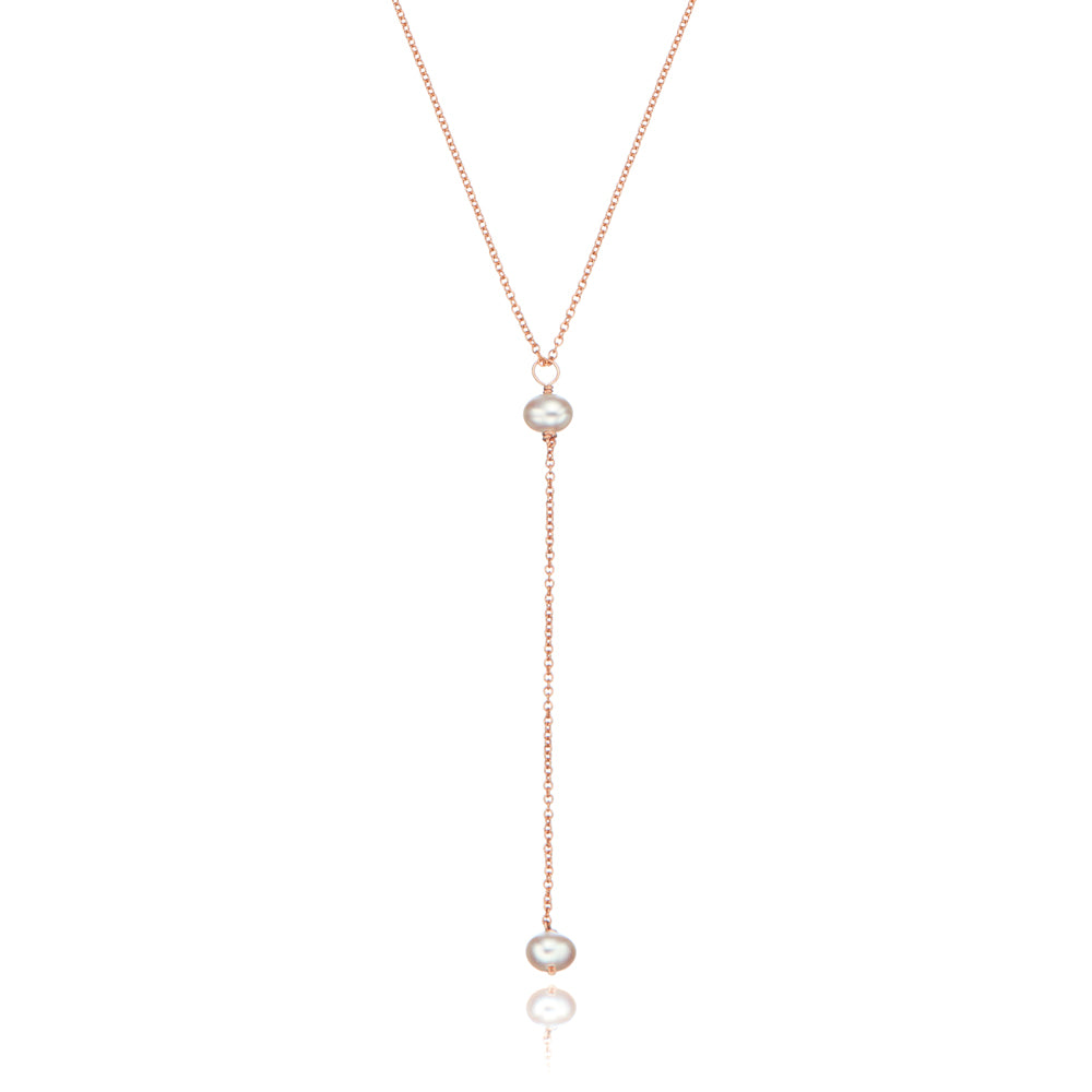 Rose gold pearl lariat necklace on a white background