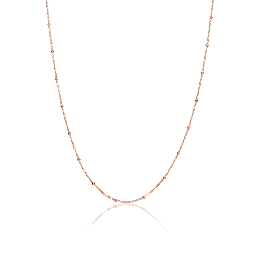 Rose gold satellite chain necklace on a white background