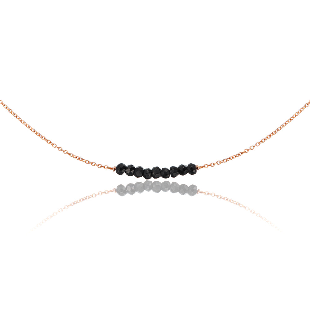 Rose gold spinel gemstone cluster choker on a white background