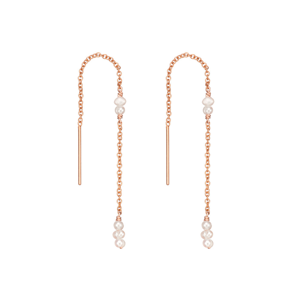 Rose gold mini pearl ear threaders on a white background