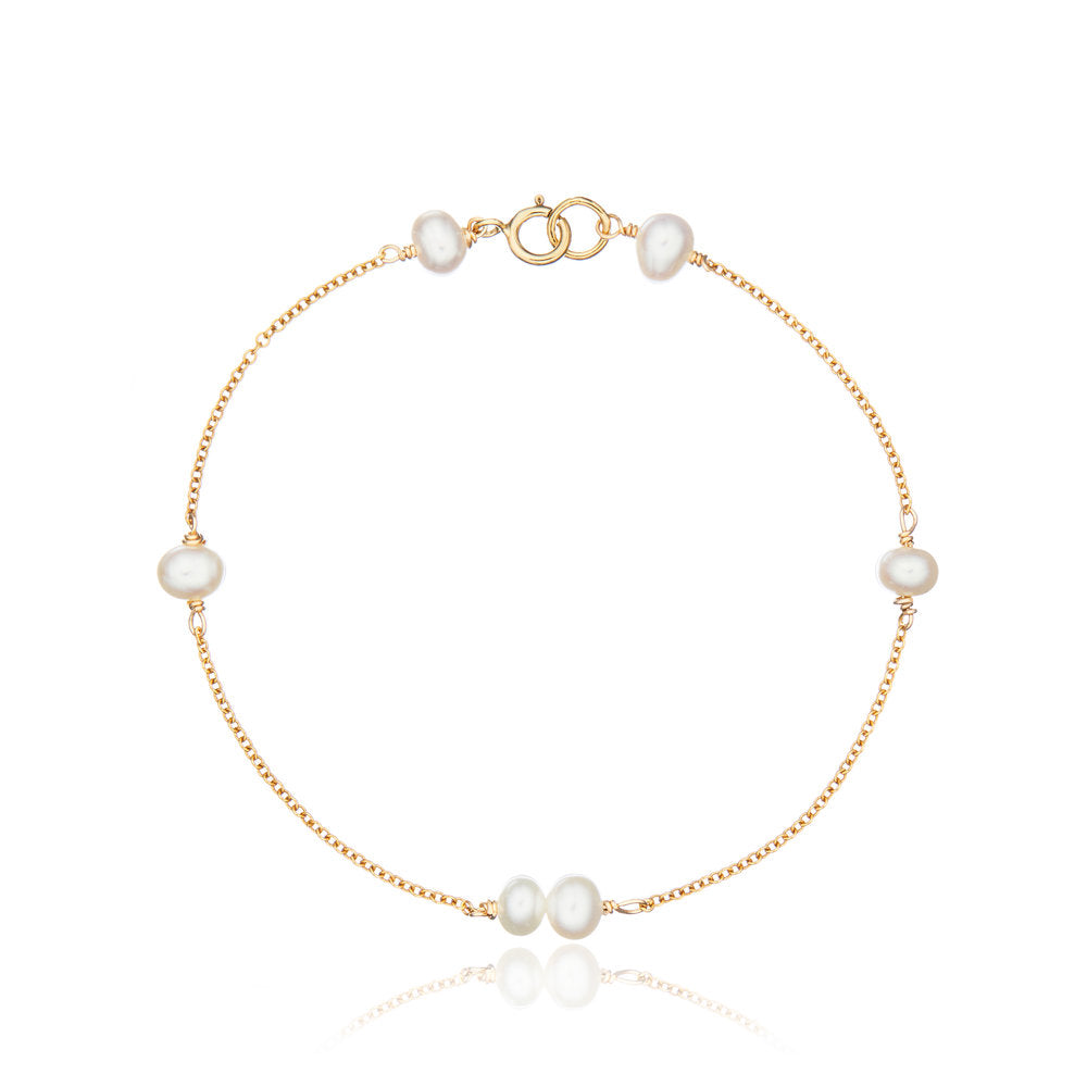 Gold six pearl bracelet on a white background