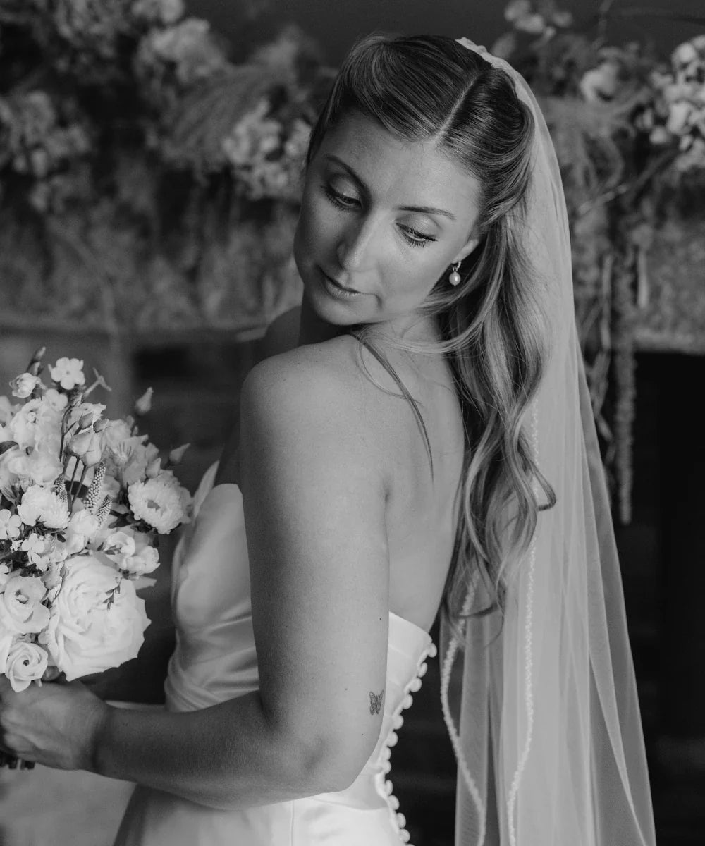 Reagan getting ready on her wedding day, wearing LILY & ROO Gold Huggie Pearl Drop Earrings.
