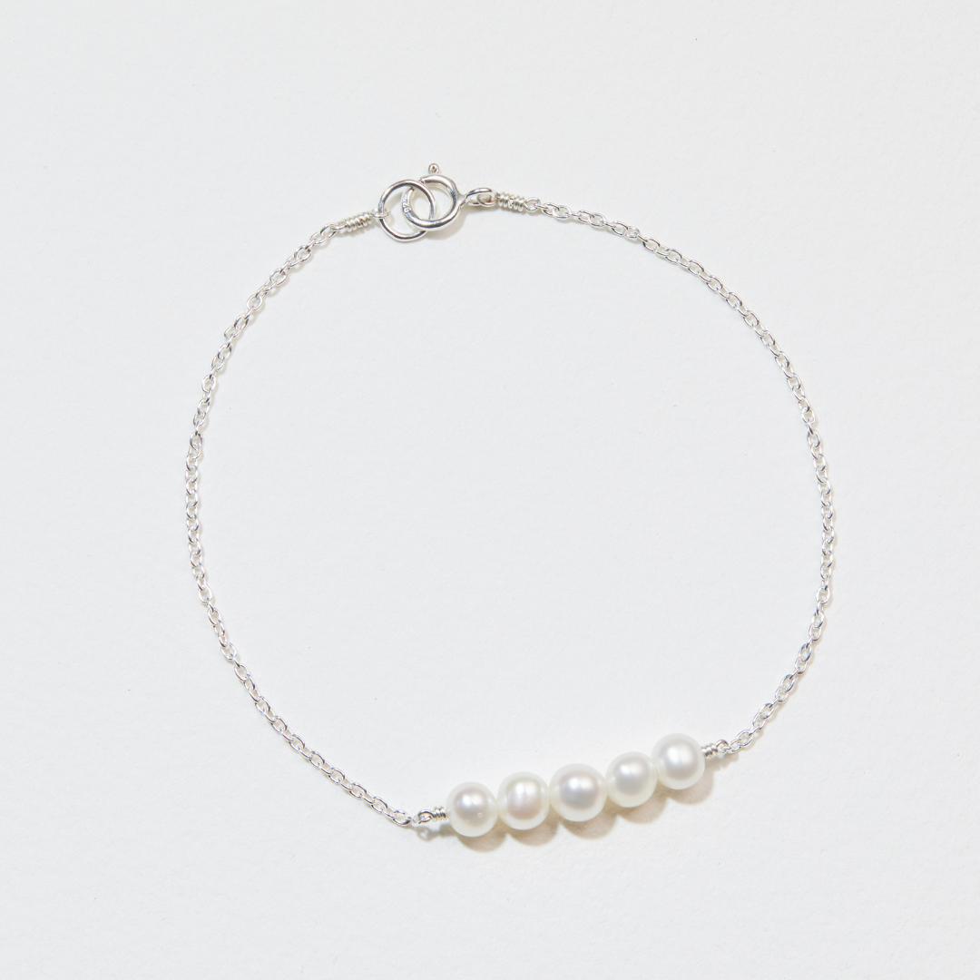 Silver cluster pearl bracelet on a white surface
