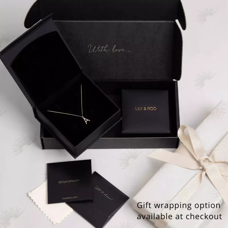 Black gift wrapping jewellery boxes open and closed with an 'A' necklace inside one