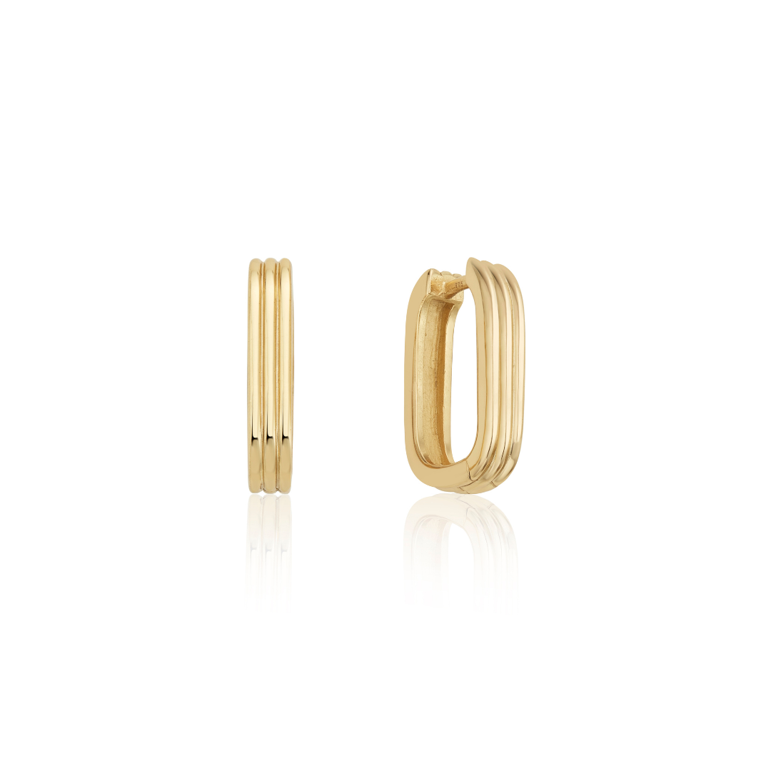 Gold ribbed hoop earrings on a white background