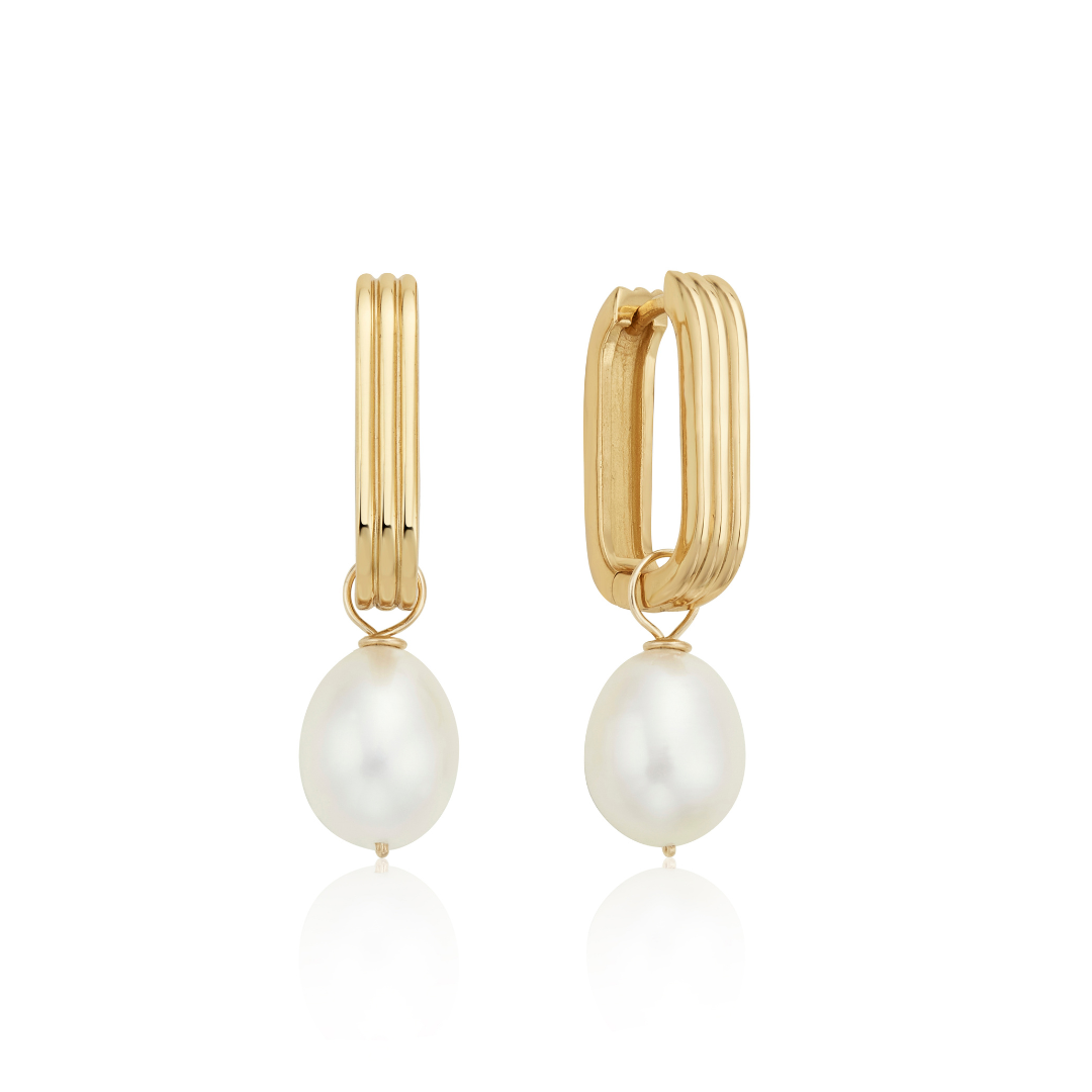 Gold ribbed pearl drop hoop earrings on a white background