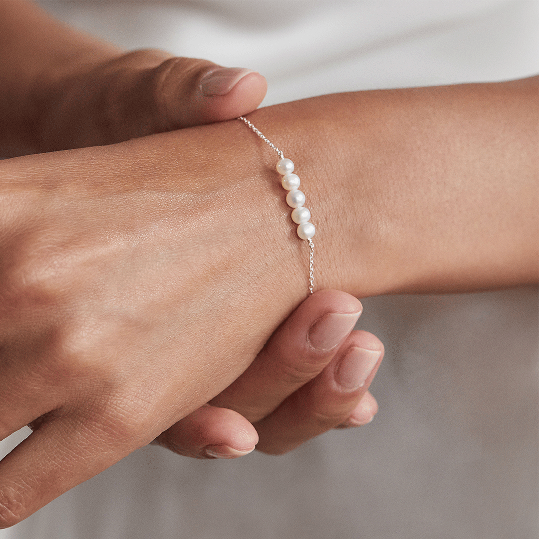 Silver cluster pearl bracelet around a wrist