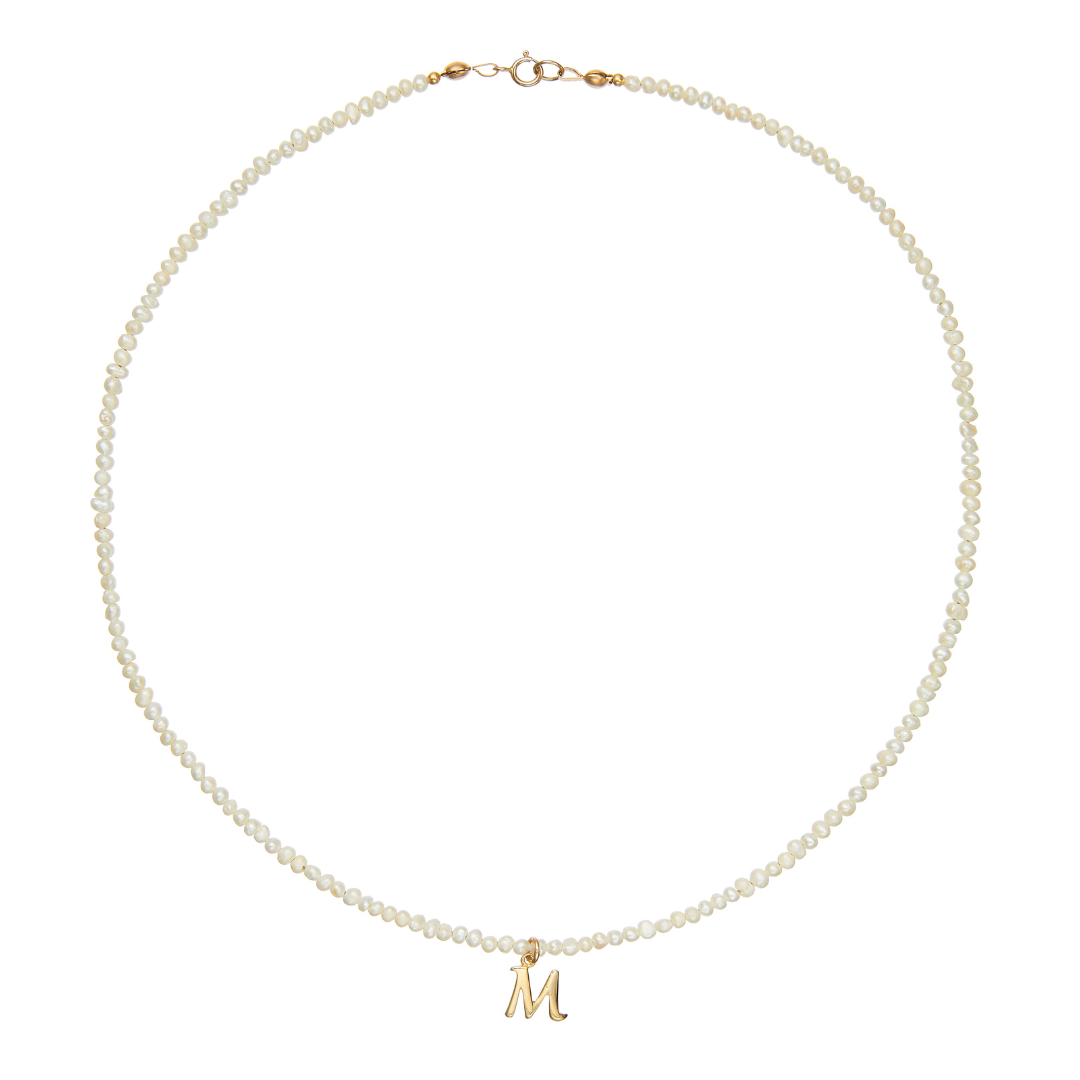 Complete gold small pearl initial letter choker on a white background