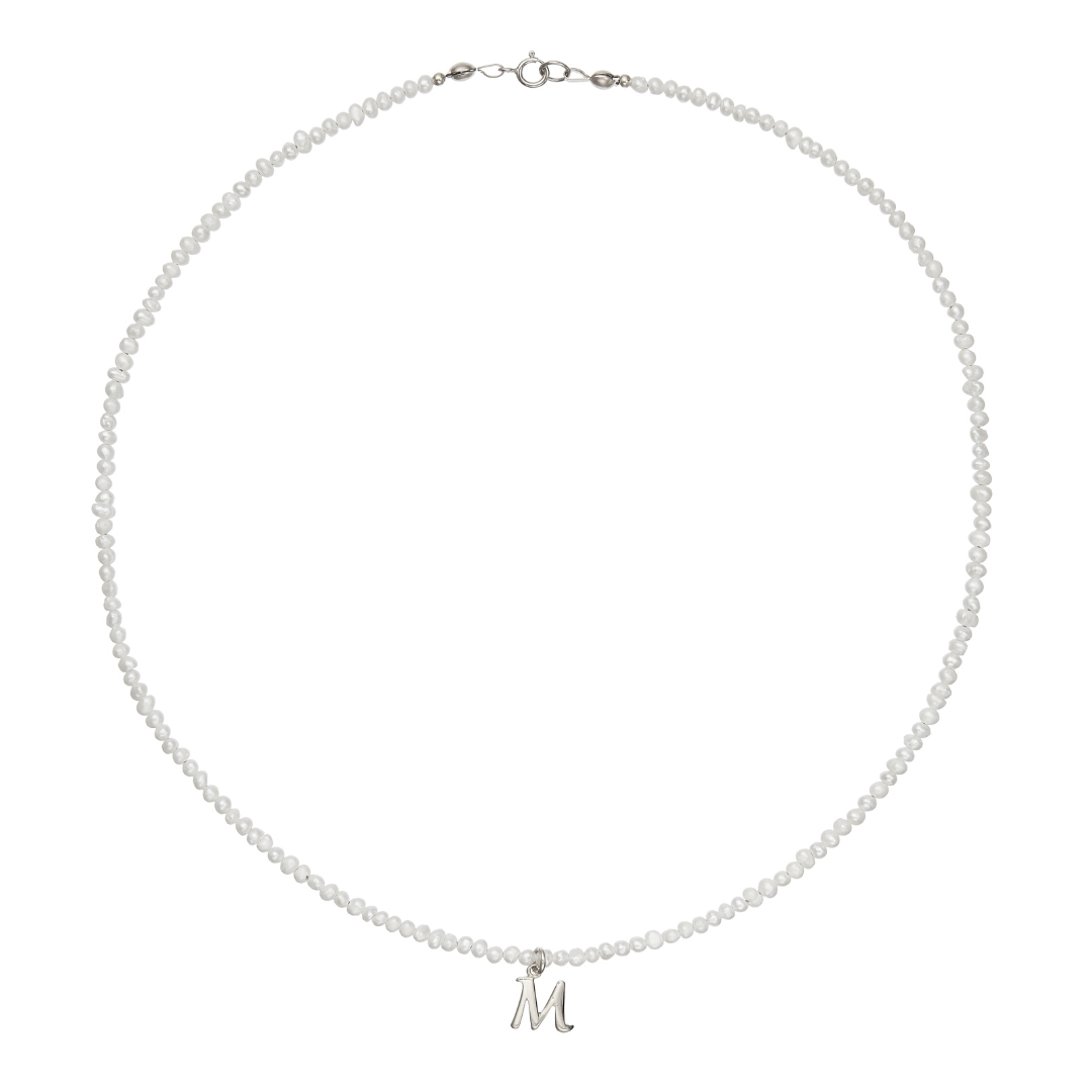 Silver small pearl initial letter choker 'M' on a white background