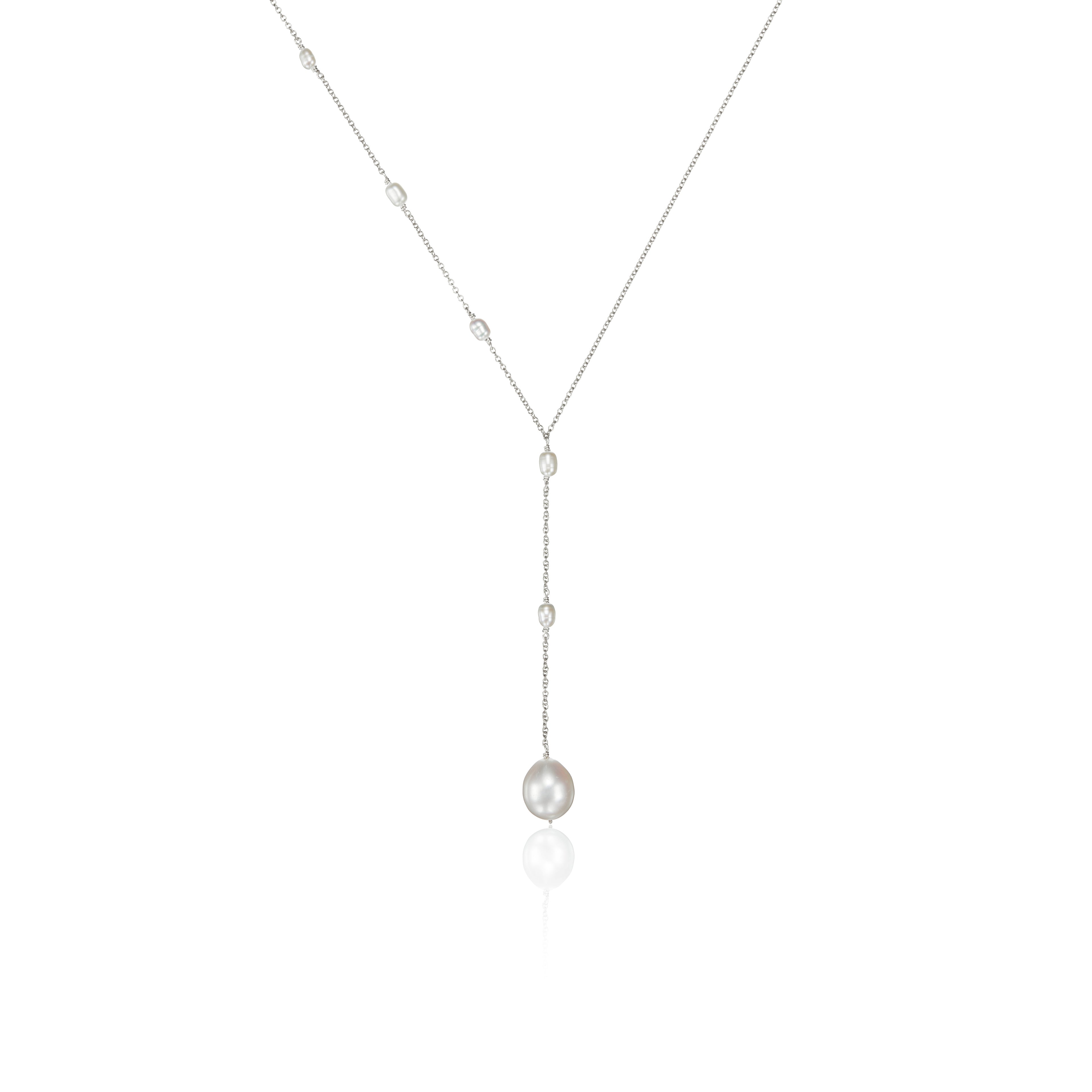 Silver seed pearl lariat necklace on a white background
