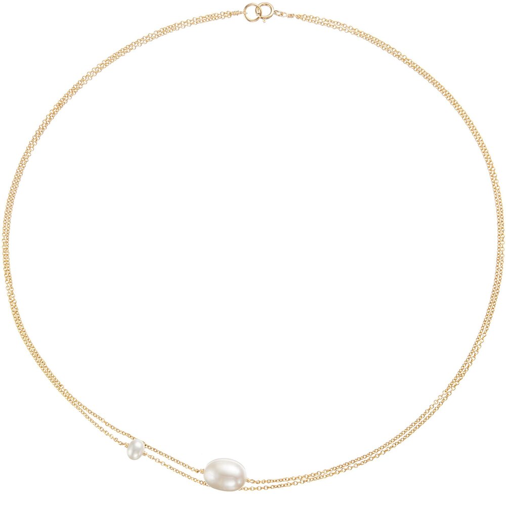 Gold layered large and small pearl choker on a white background