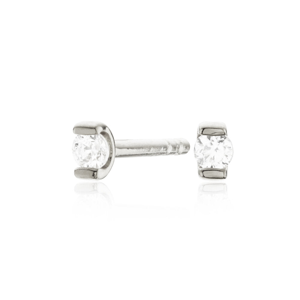 Silver small diamond style studs on a white background