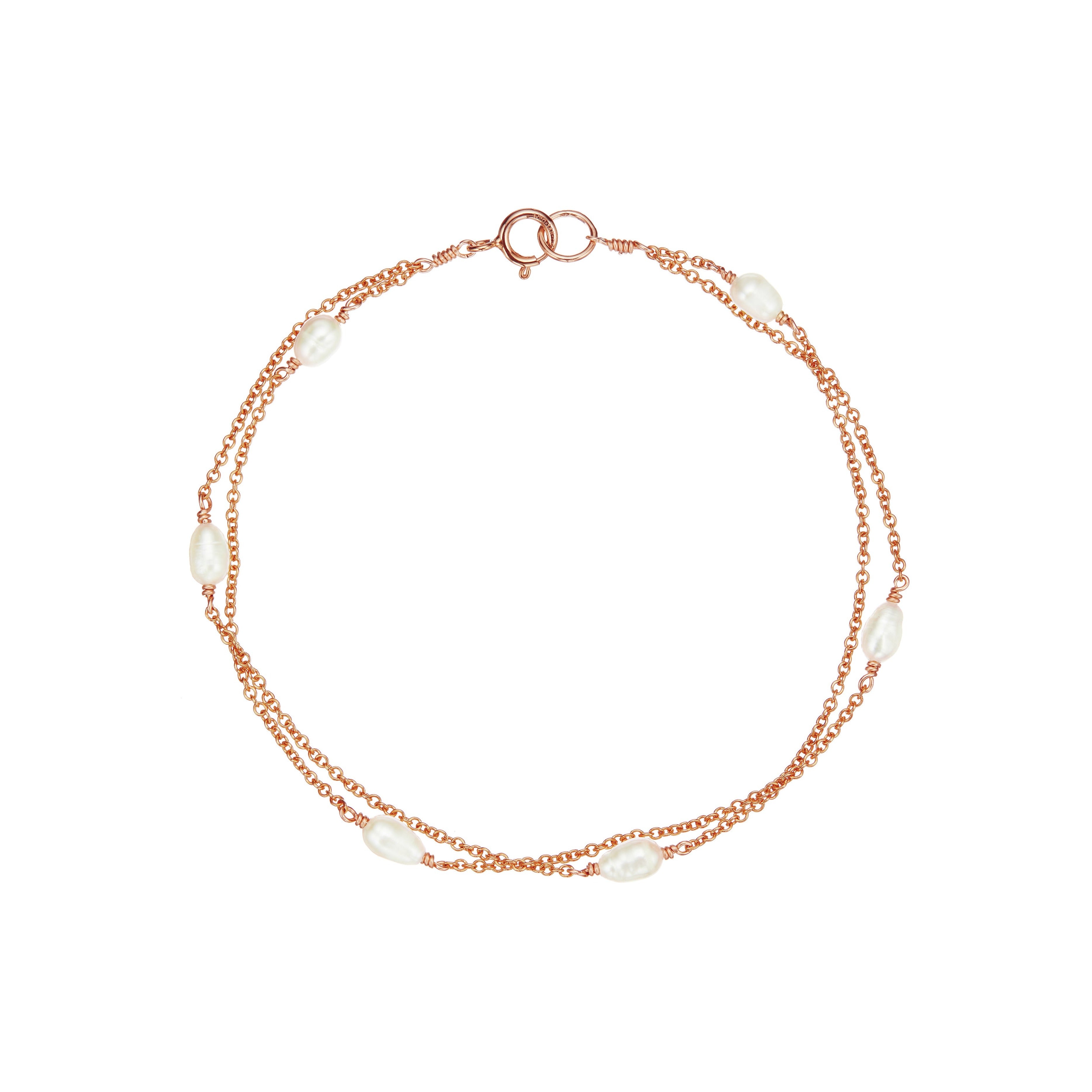 Rose gold layered seed pearl bracelet on a white background