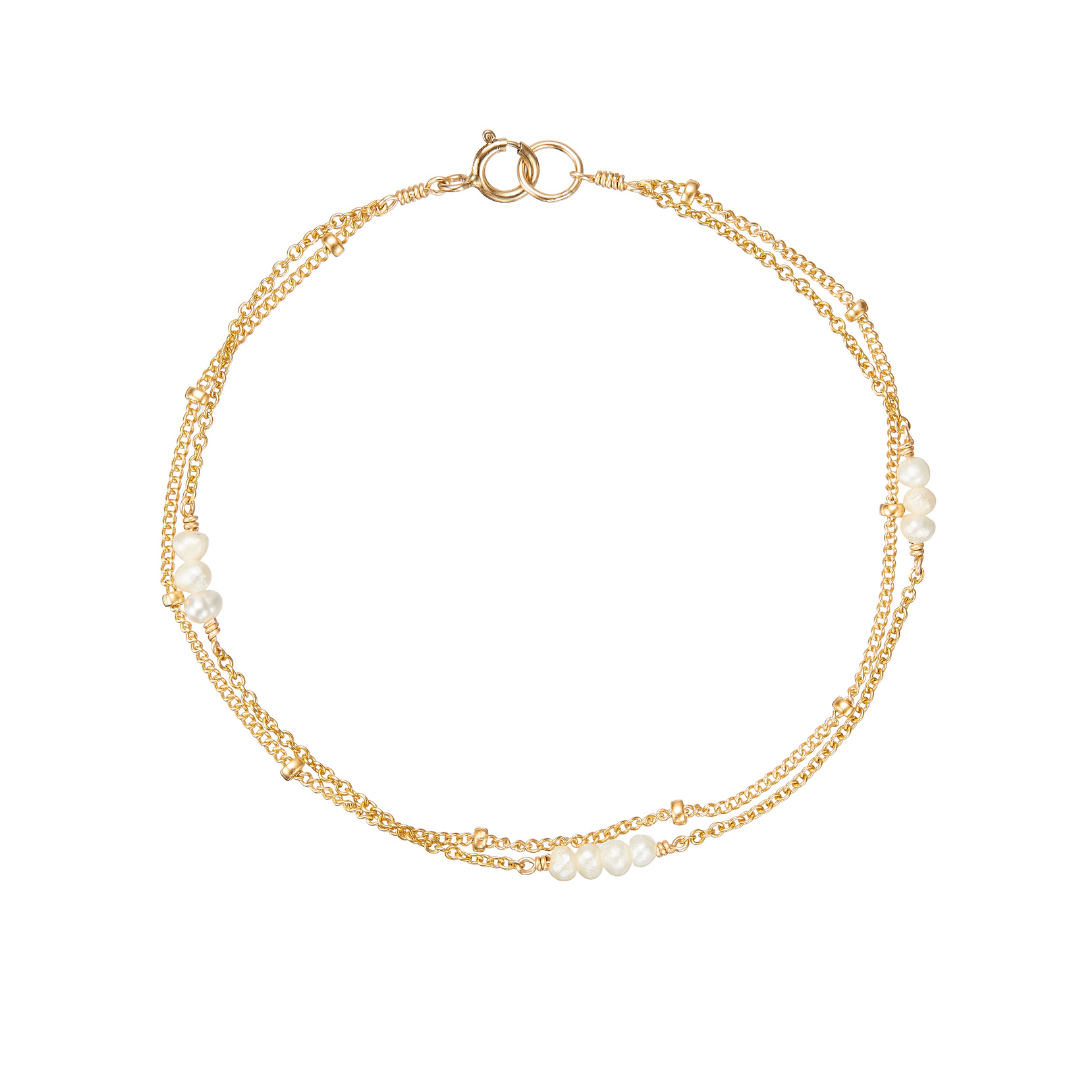 Gold layered satellite mini pearl bracelet on a white background