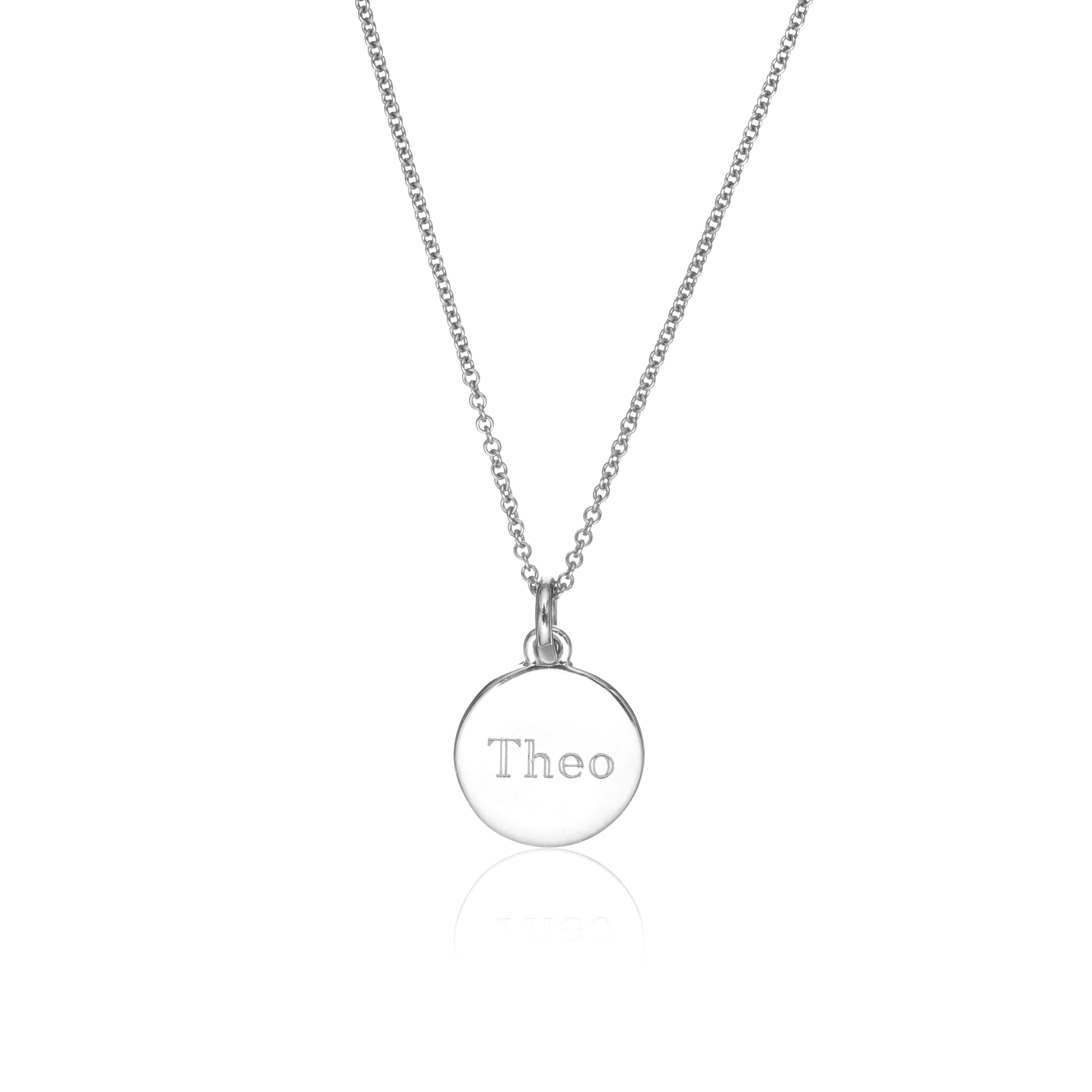 Silver small round engraved disc necklace with the name 'Theo' engraved on a white background