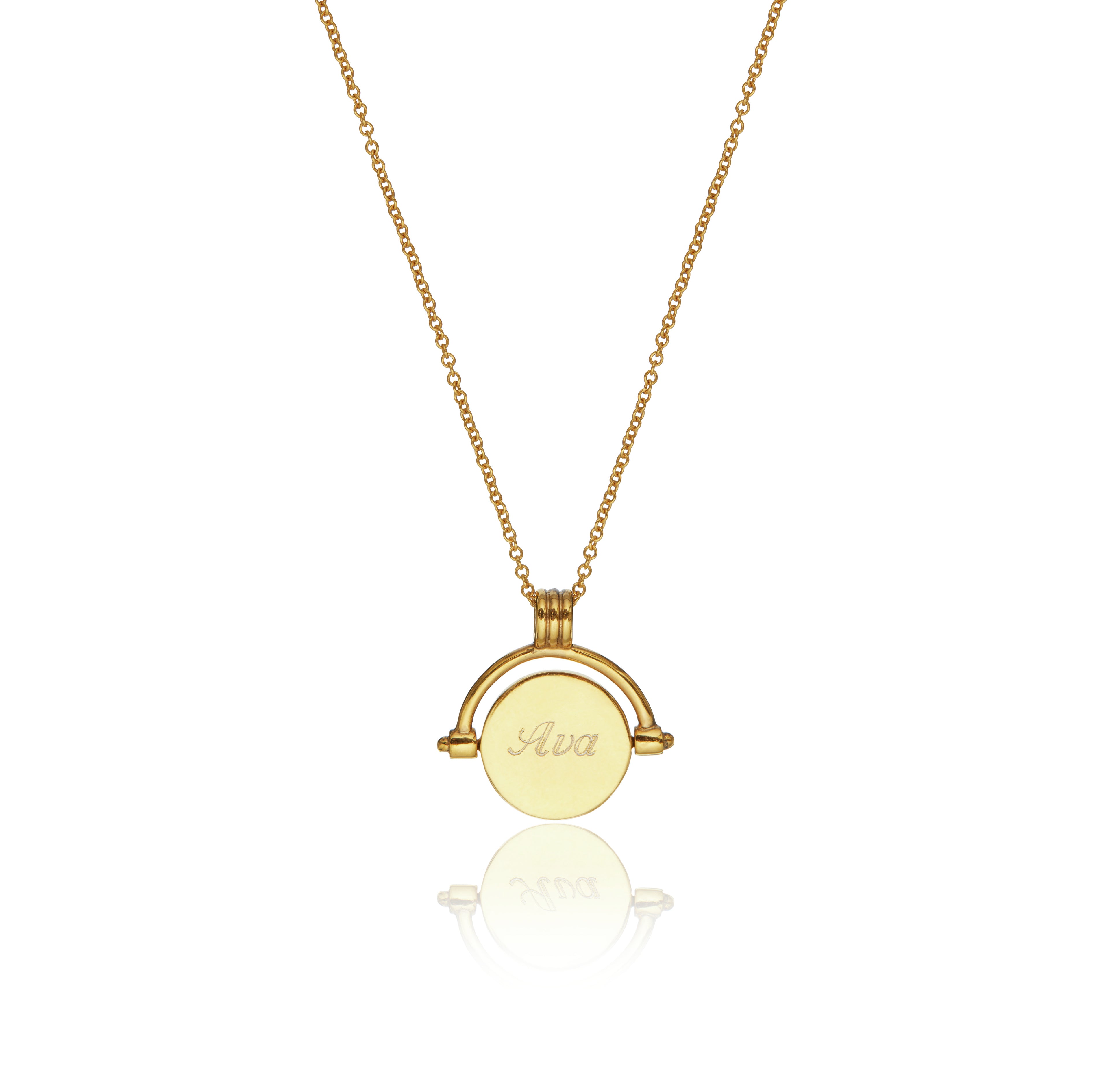 The back of the gold mother of pearl spinning disc necklace with Ava engraved on it on a white background