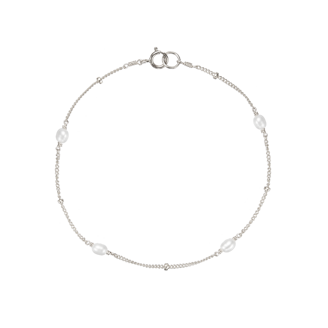 Silver seed pearl satellite bracelet on a white background