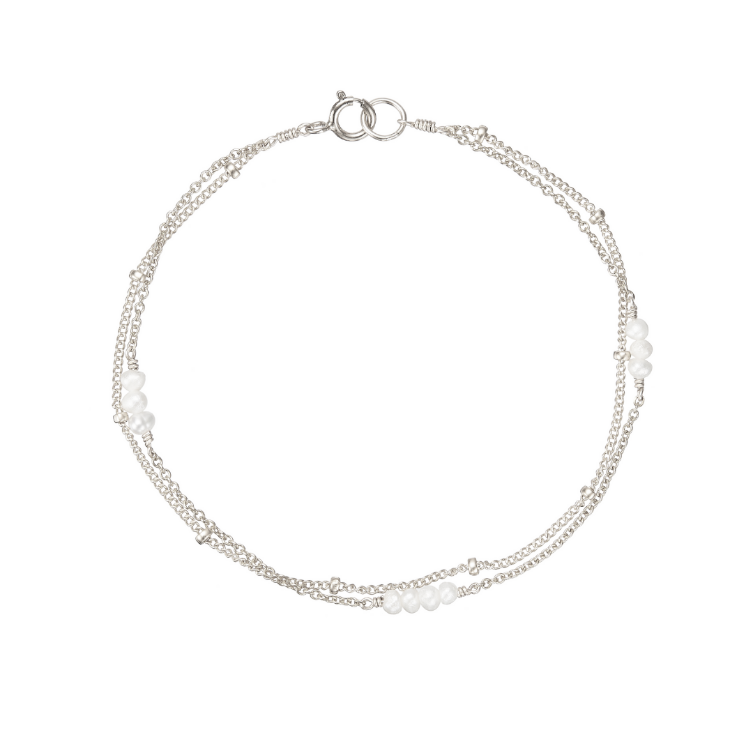 Silver layered satellite mini pearl bracelet on a white background