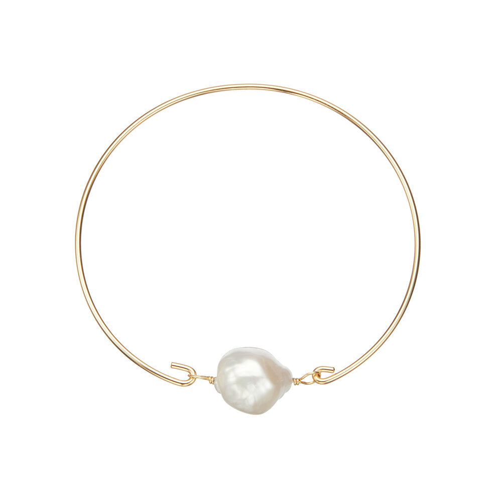 Baroque gold bangle with pearl on white background