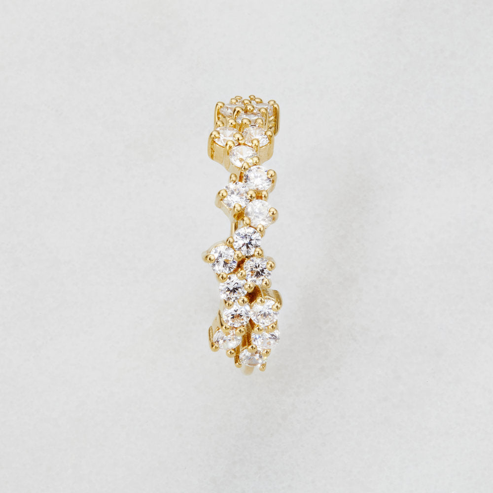 Gold diamond style cluster ring on a white surface birds eye view