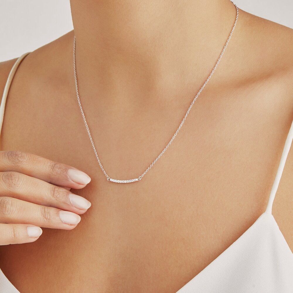 Silver diamond style bar necklace around a neck