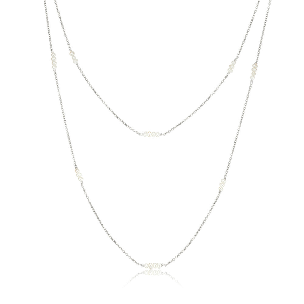 Silver layered mini pearl necklace on a white background