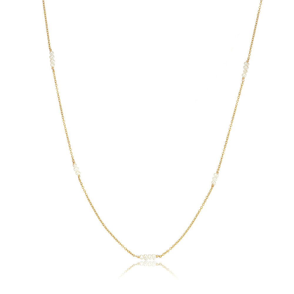 Gold mini pearl necklace on a white background