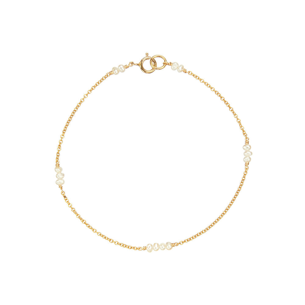 Gold mini pearl bracelet on a white background