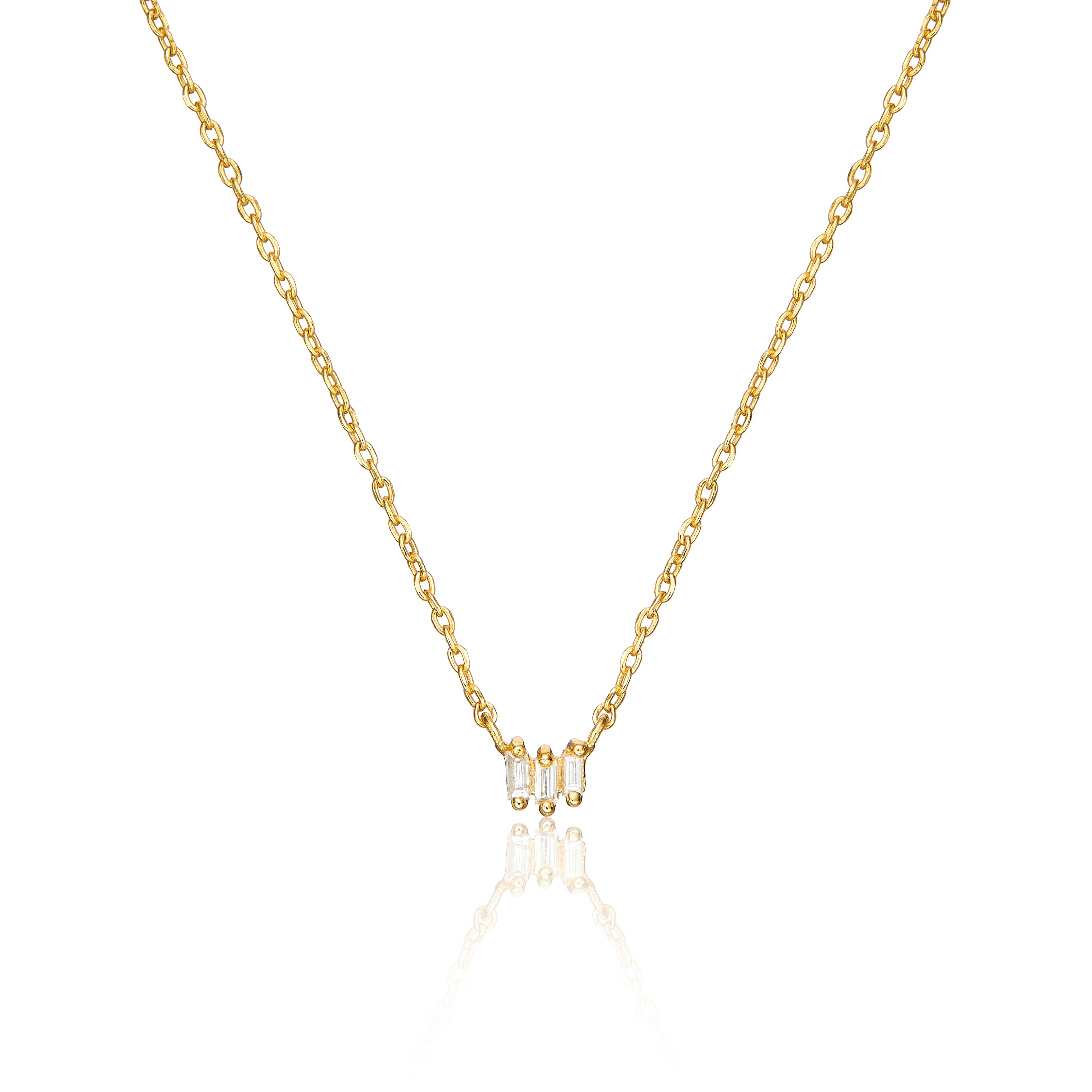 Gold triple baguette diamond necklace on a white background