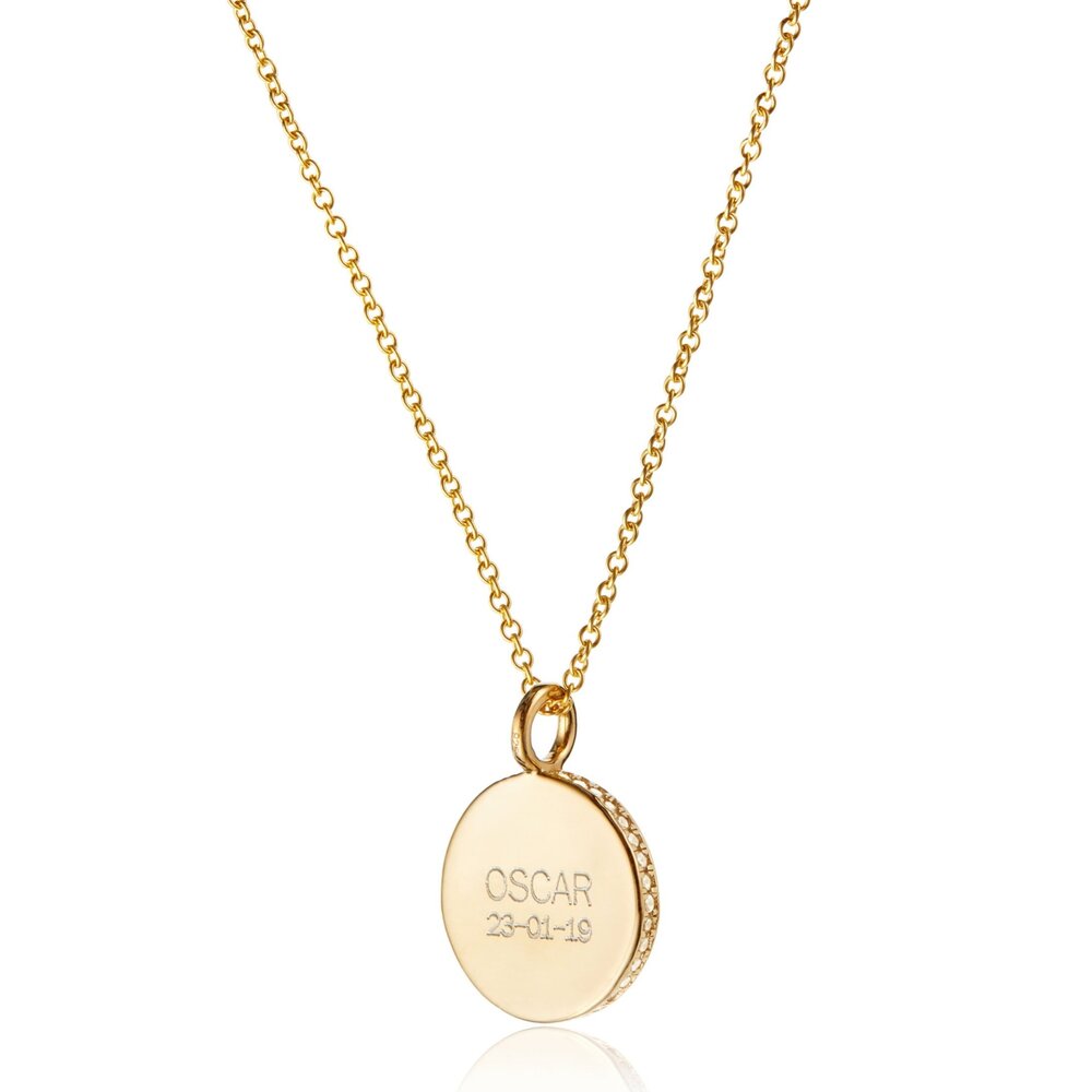 Gold small diamond style disc necklace with 'OSCAR 23-01-19' engraved on it on a white background